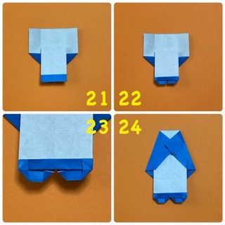 How to fold 帽子ねこ（くま）🐱🐻: 21裏返したところです。
22  靴の部分を、上の一枚だけ半分に折り、両端は三角に折り潰します。
23  拡大したところです。
24  上の両角が真ん中あたりにくるように折ります。ここが体になるので、お好みの角度で折って下さい。これで完成です。